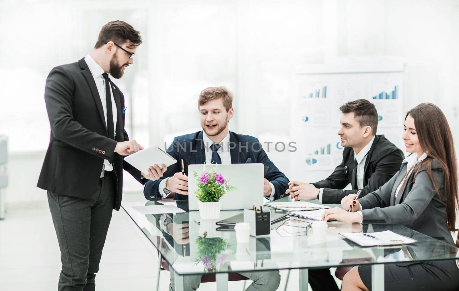 business partners discuss the profits before signing the contract in the workplace in a modern office.the photo has a empty space for your text
