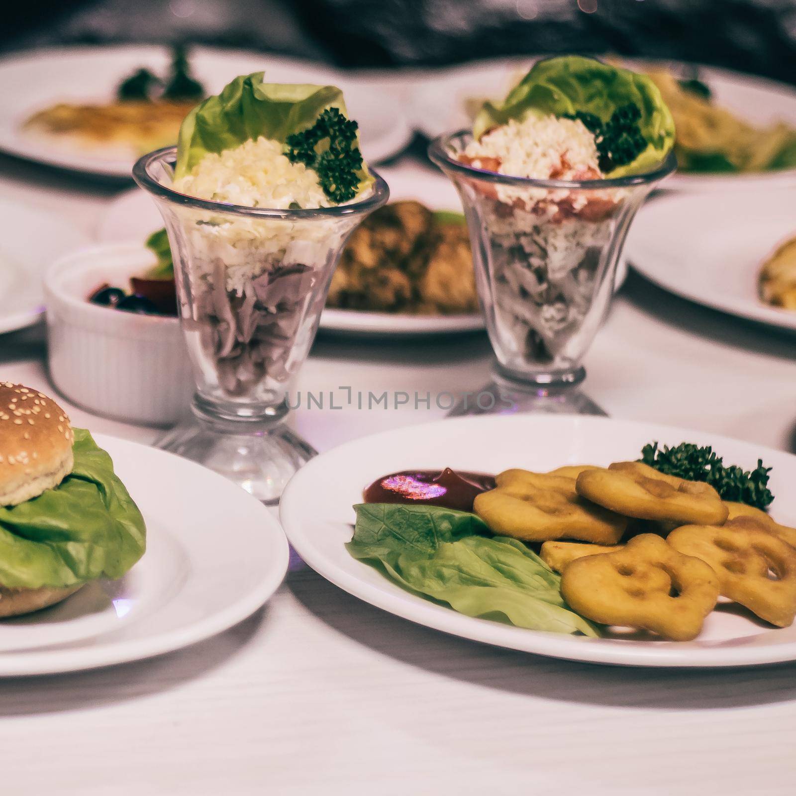 hamburger and other fast food on the table in the cafe.