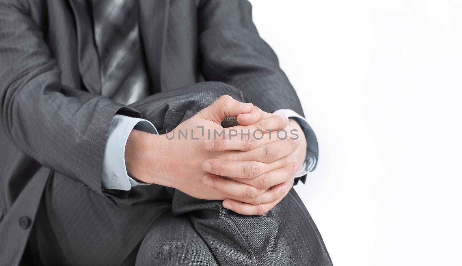 closeup. businessman sitting on an office chair.isolated on white