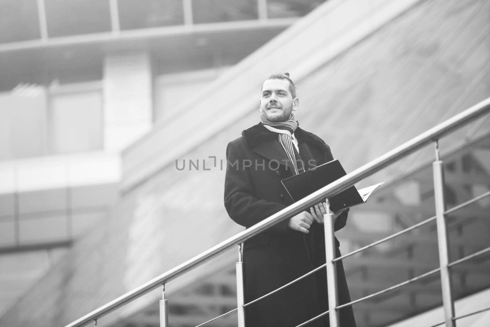 modern business man with papers ,comes into his office