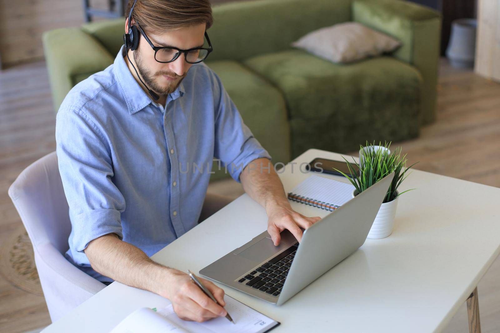 Freelance operator talking with headsets and consulting clients from home office