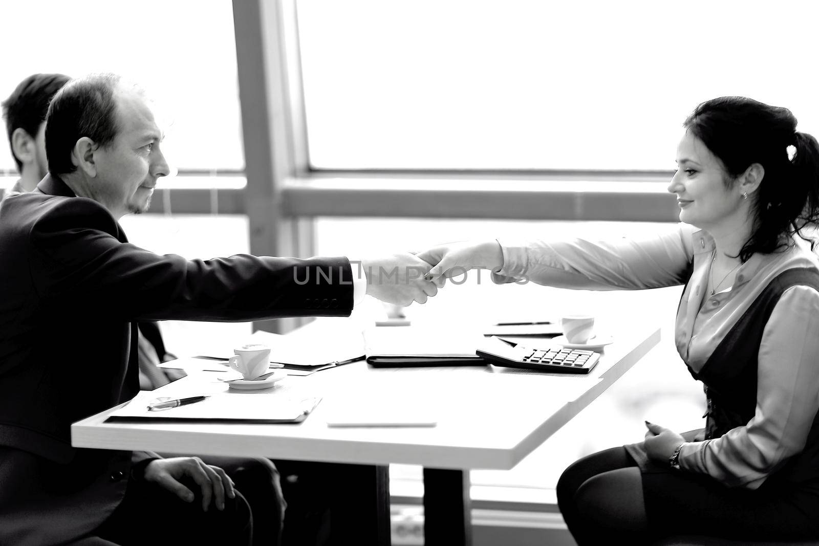 handshake of a businessman and business woman over a Desk.concept of partnership
