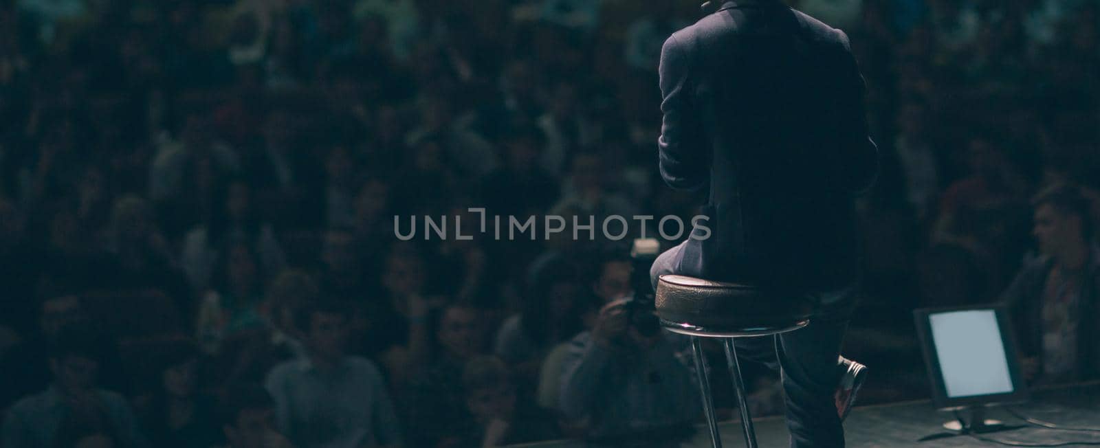 businessman makes a report to the audience in the conference room . photo with copy space