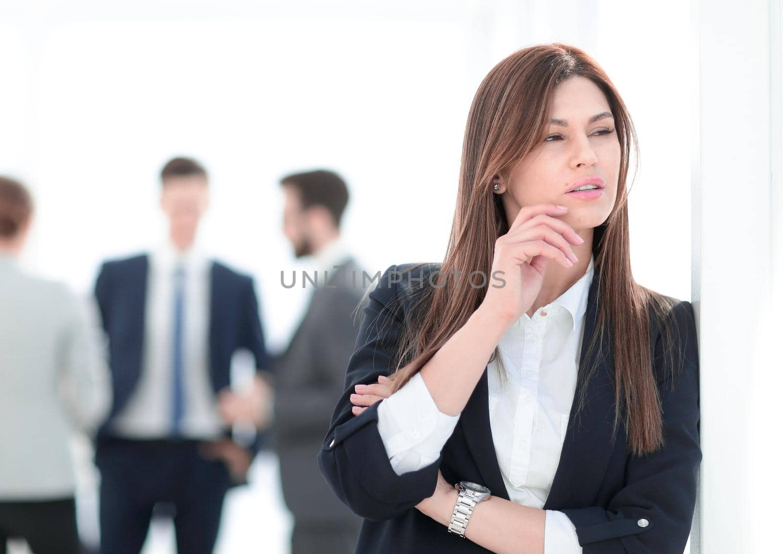 pensive business woman on blurred office background. photo with copy space