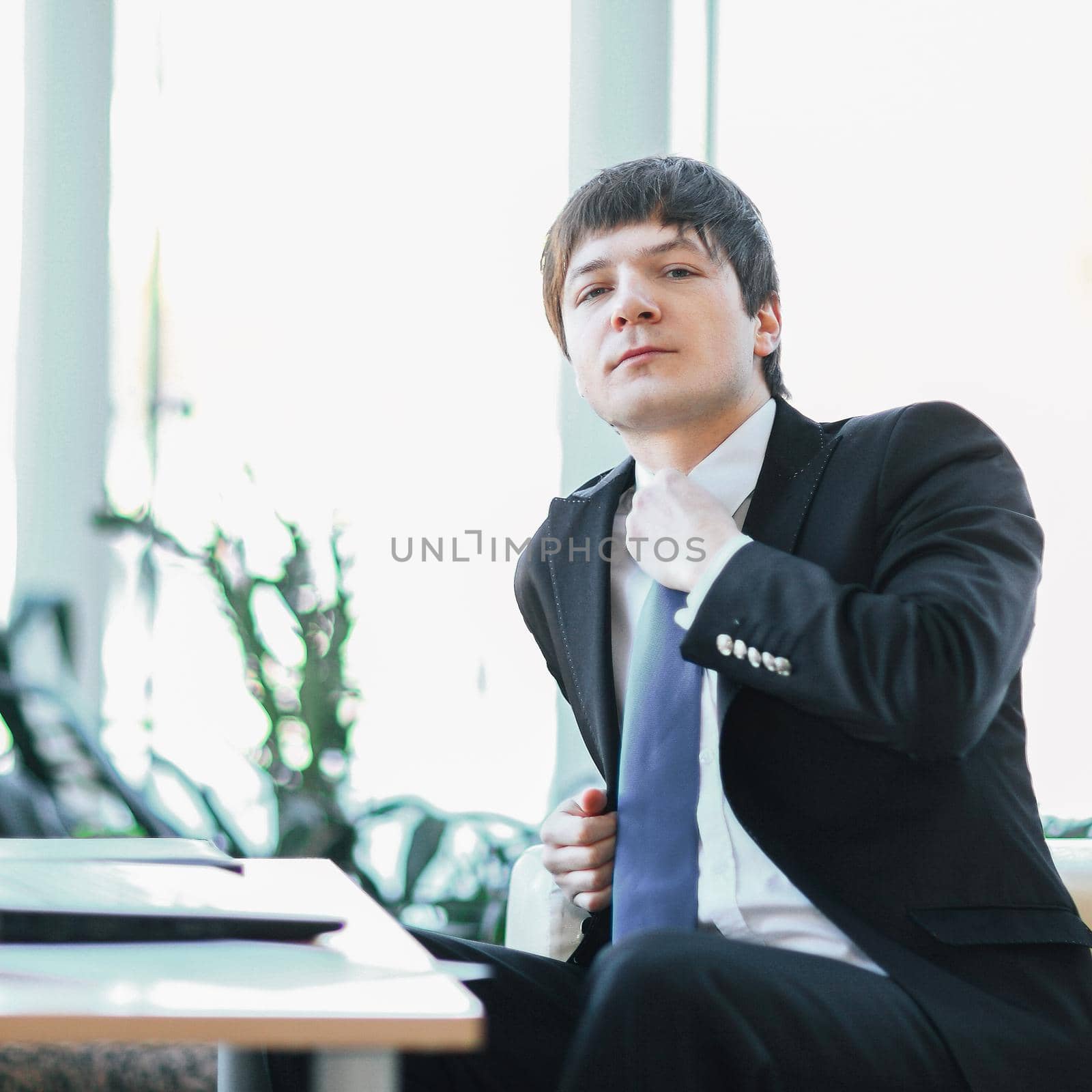 portrait of a young businessman on workplace in the office.