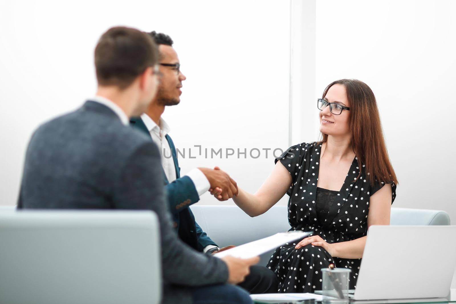 welcoming handshake of a businessman and businesswoman . photo with copy space