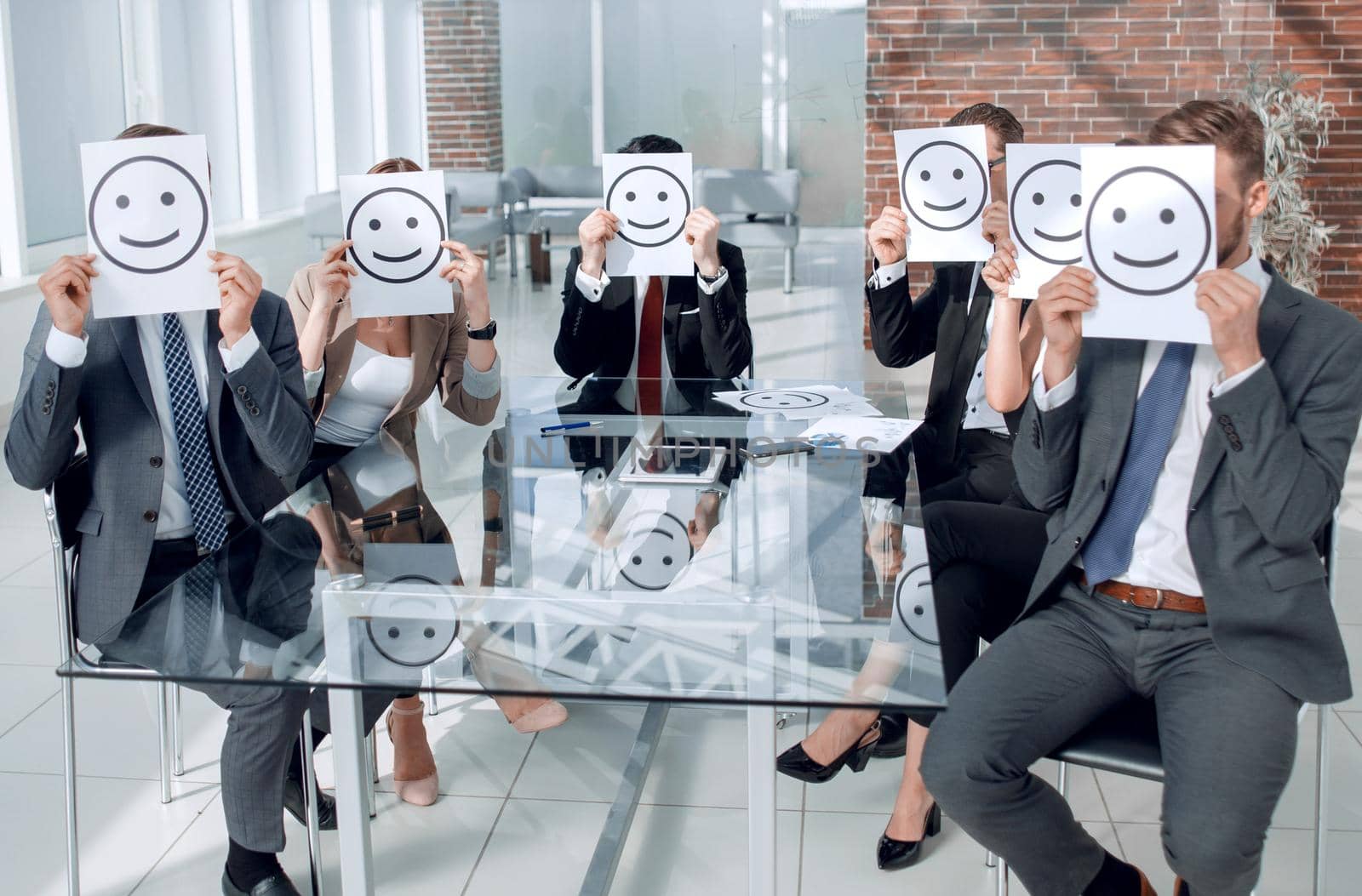 Business Team holding a paper with a positive smiley by asdf