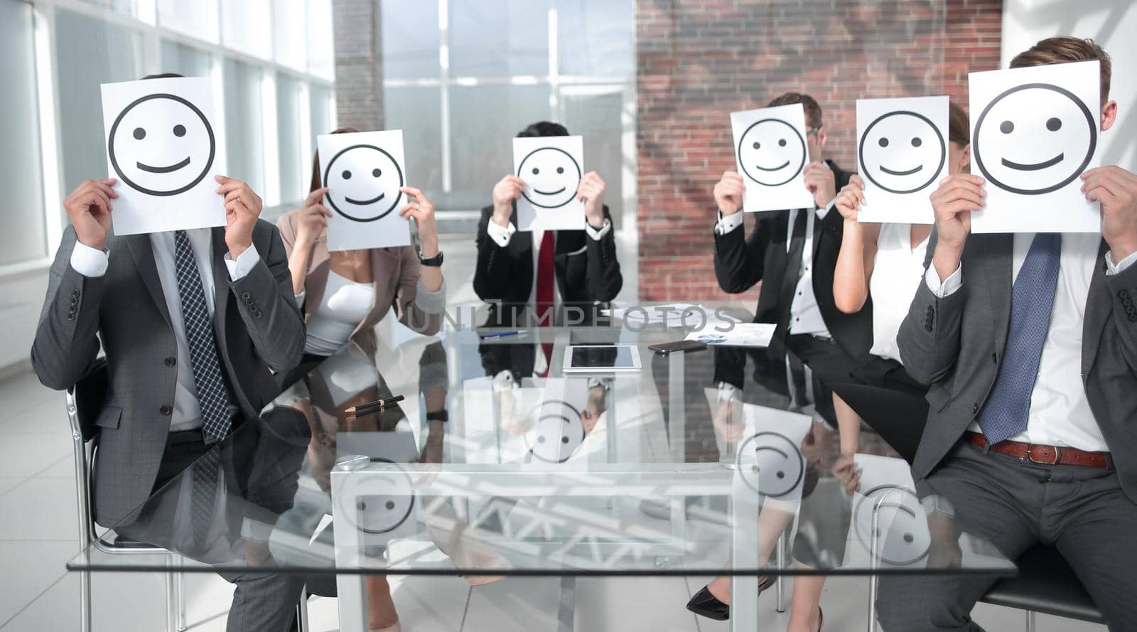 Business Team holding a paper with a positive smiley by asdf