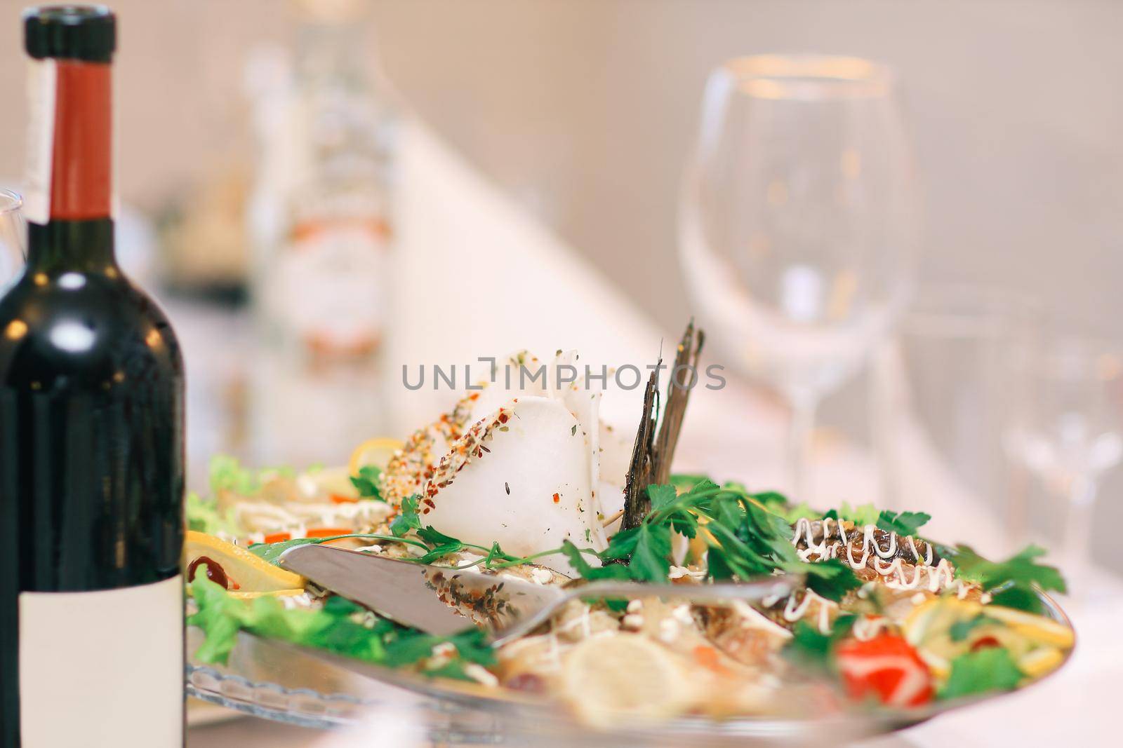 close up.a bottle of wine and a snack on the festive table.