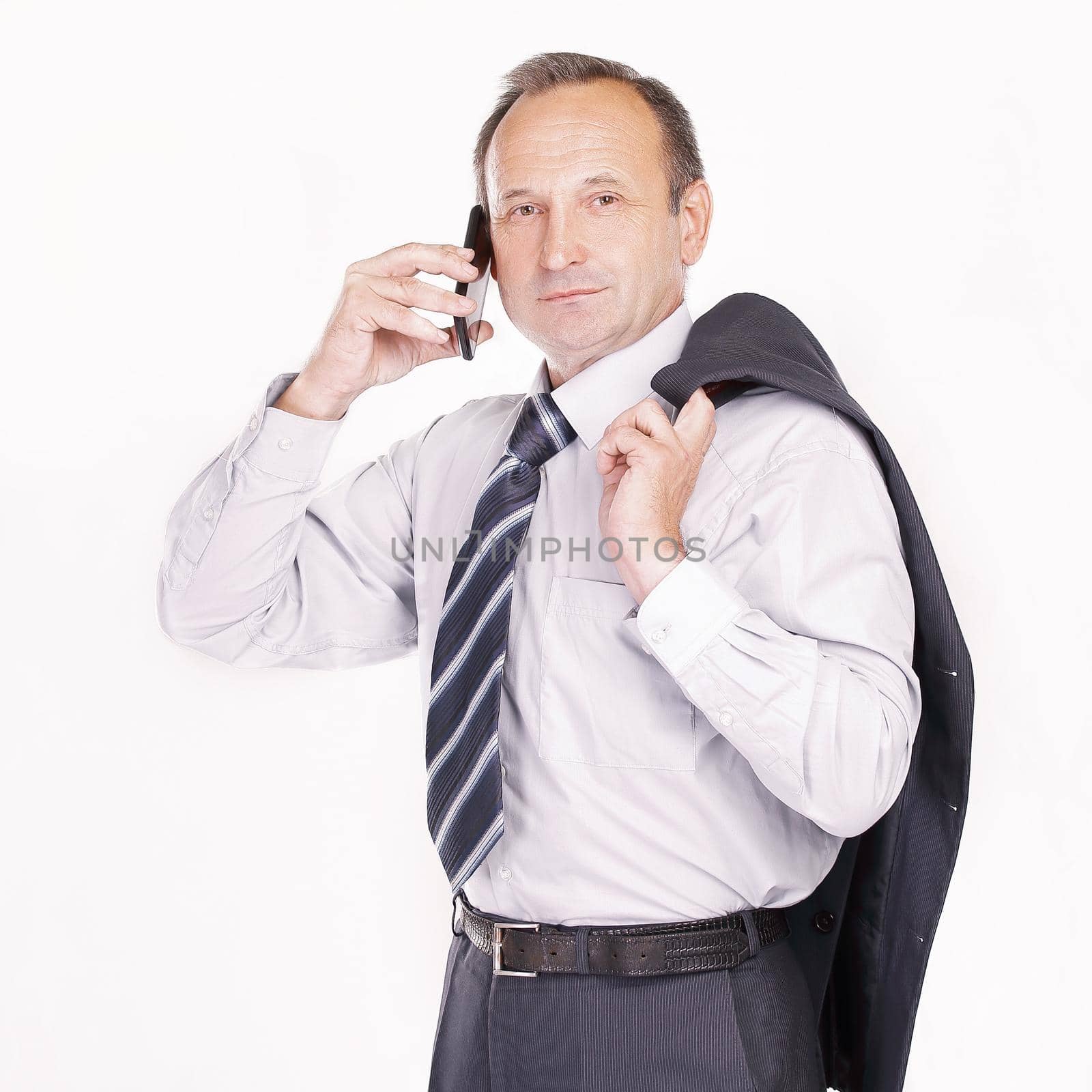 serious businessman talking on a mobile phone.isolated on light background