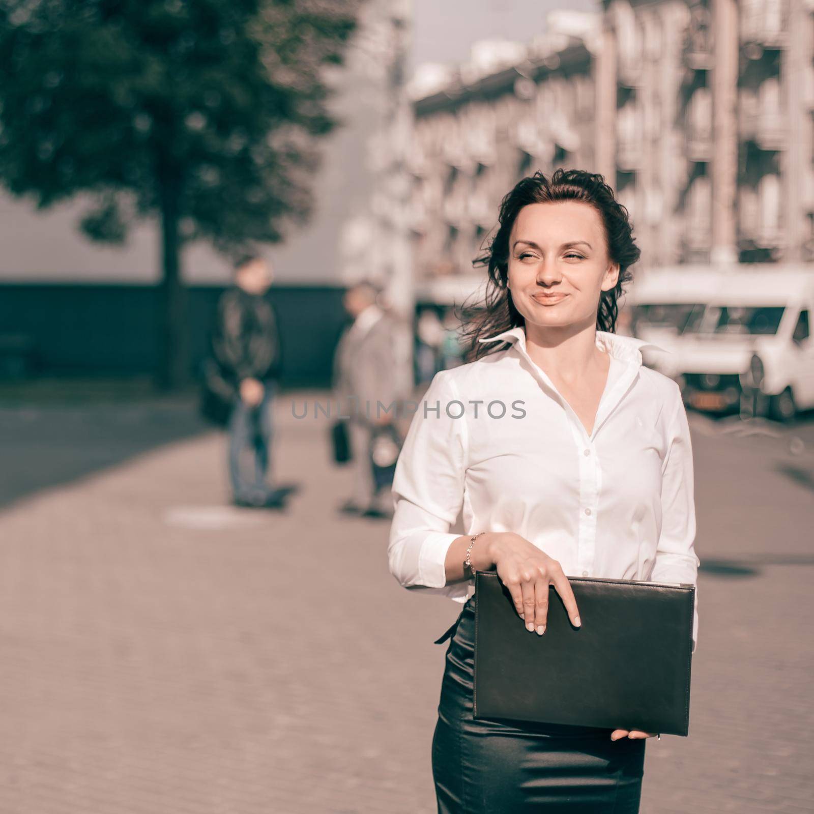 happy businesswoman with clipboard standing on city street by SmartPhotoLab