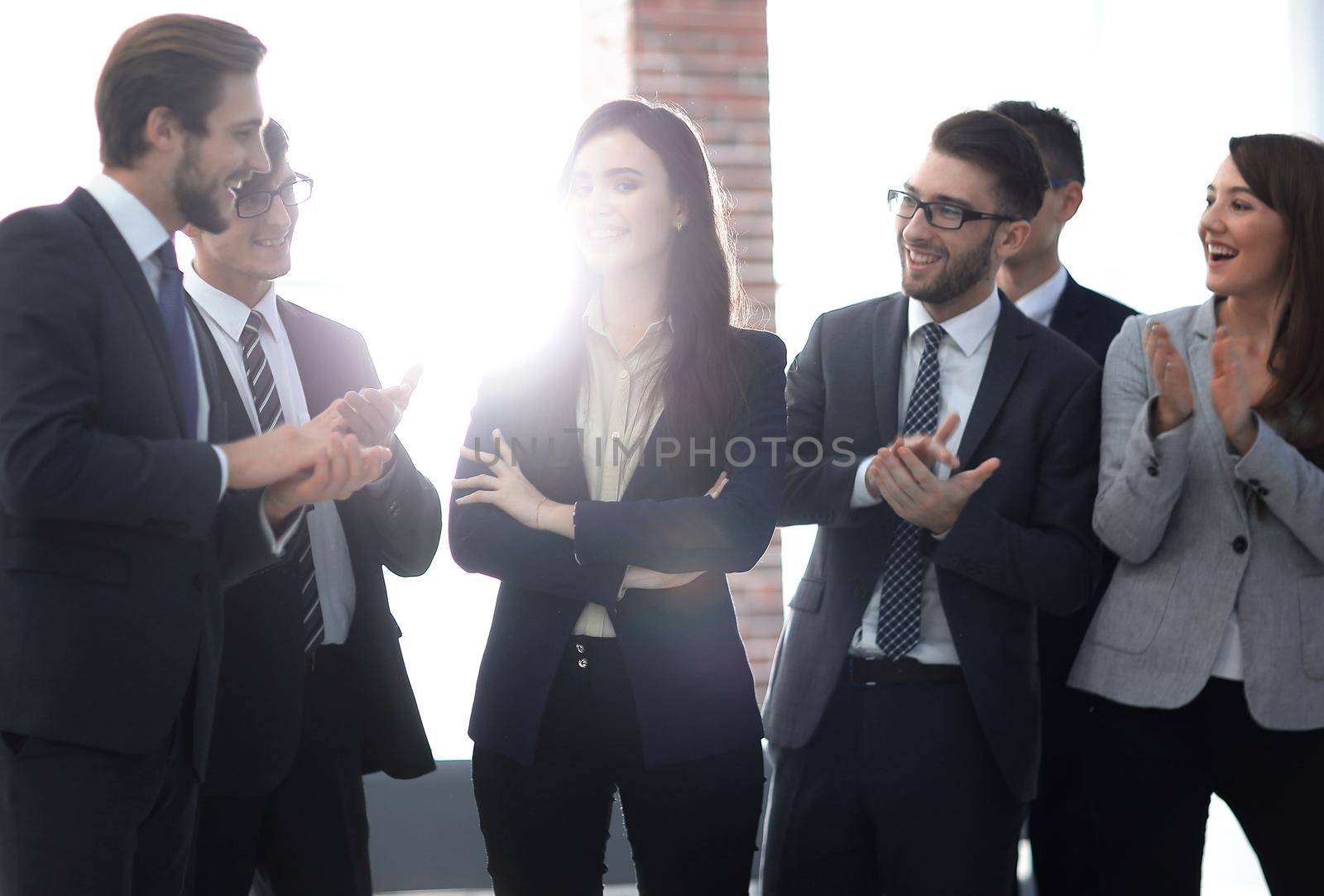 Portrait of businesspeople looking at camera with female leader by asdf
