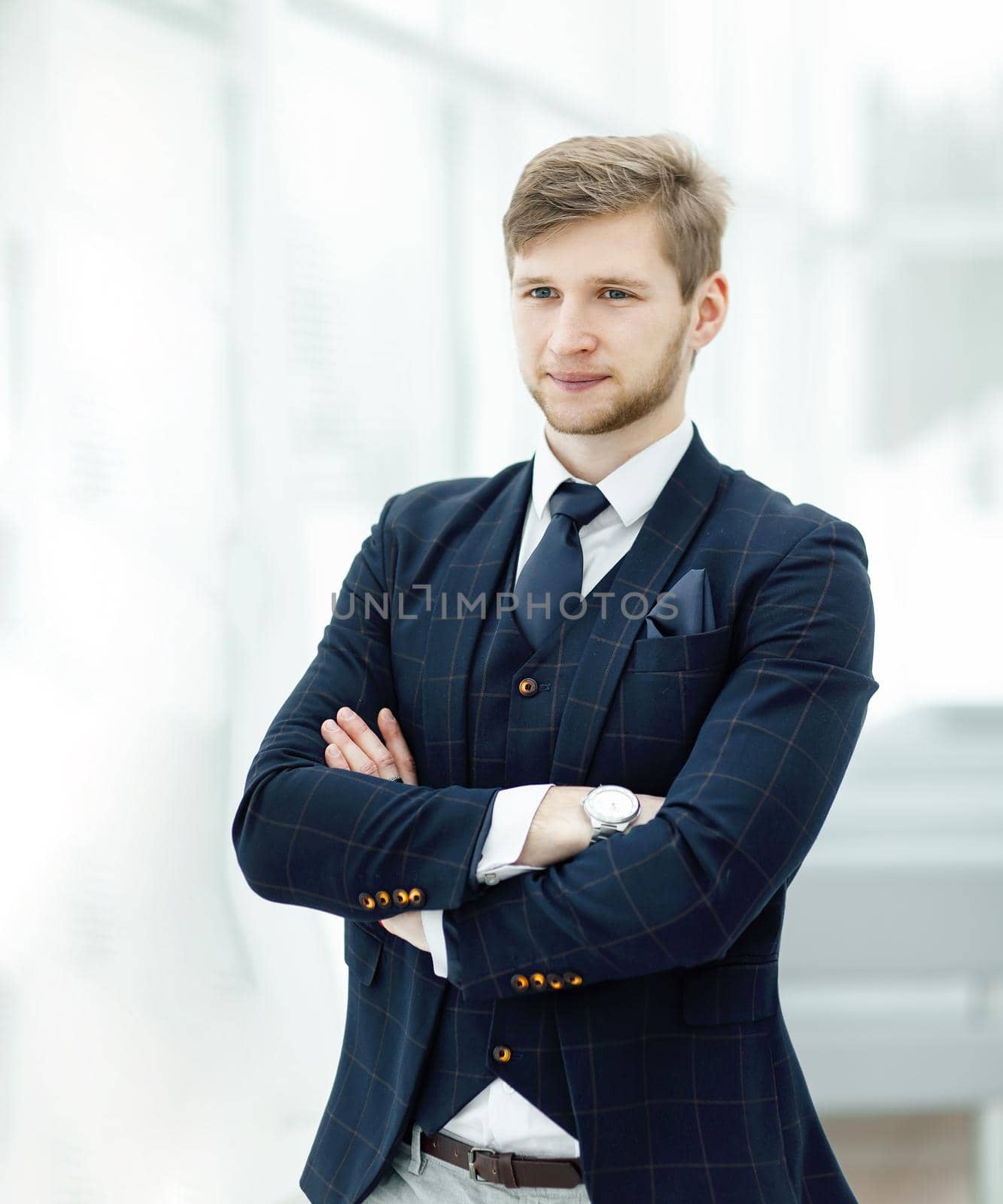 pensive young businessman standing near the office window by SmartPhotoLab