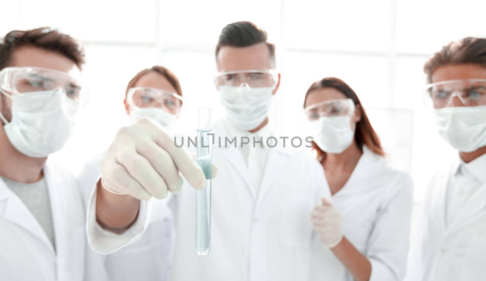 closeup of a group of medical workers working with liquids in laboratory