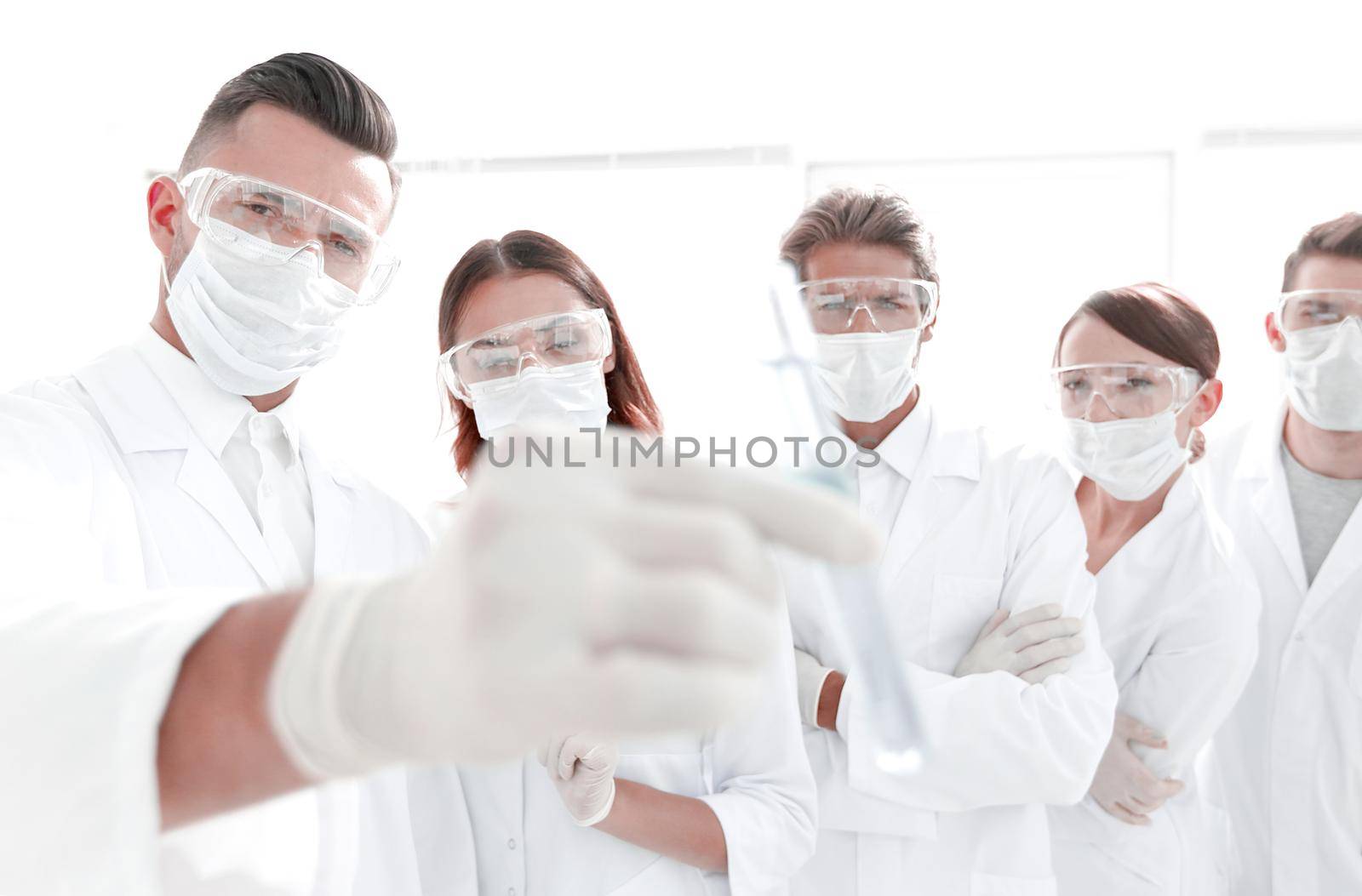 background image is a group of medical workers working with liquids in laboratory .photo with copy space