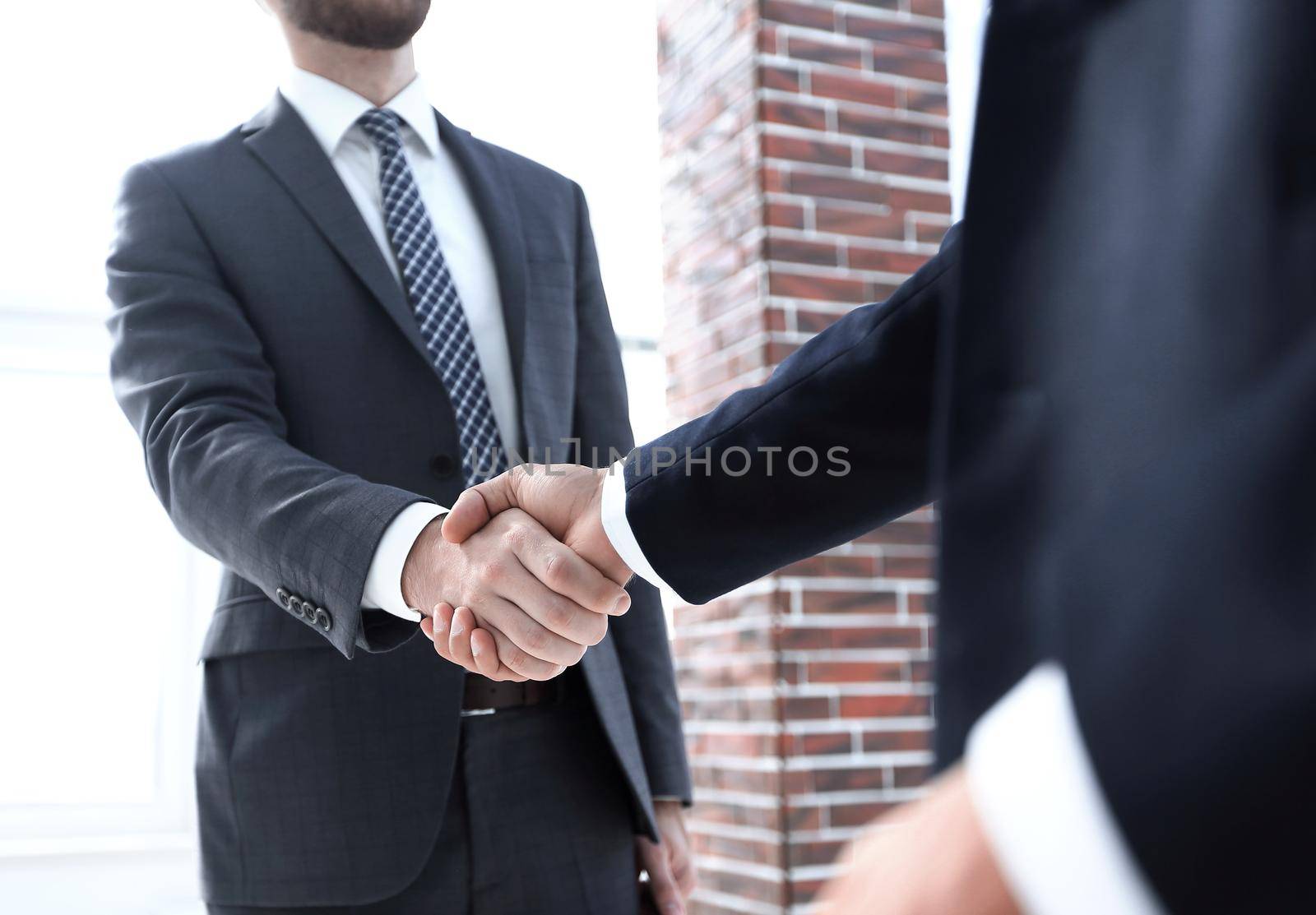 business leader shaking hands with partner. by asdf