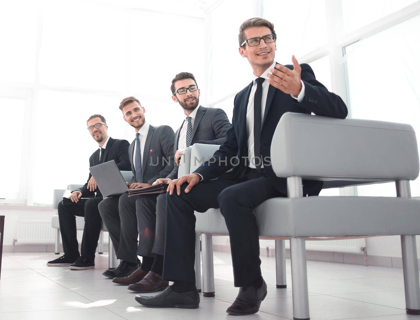 group of young businessmen sitting in the lobby of the business center.photo with copy space