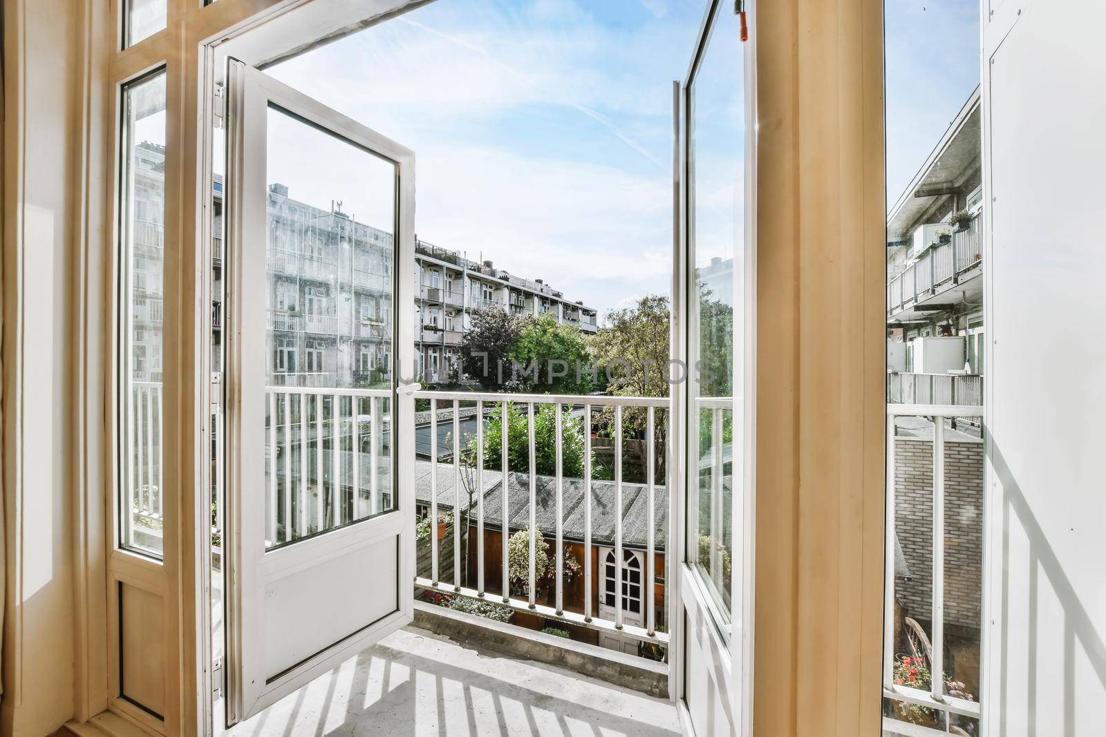 Open doors leading to a balcony with a beautiful view