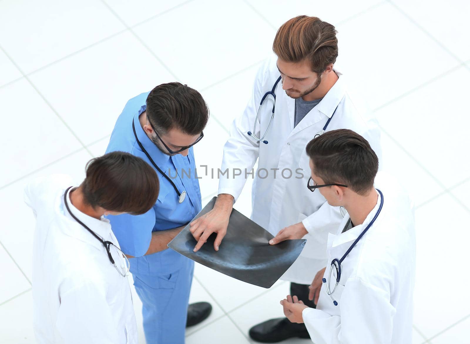 group of doctors discussing an x-ray.isolated on white. by asdf