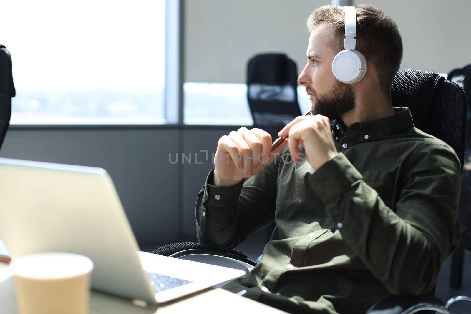 Young modern business man sitting in the office