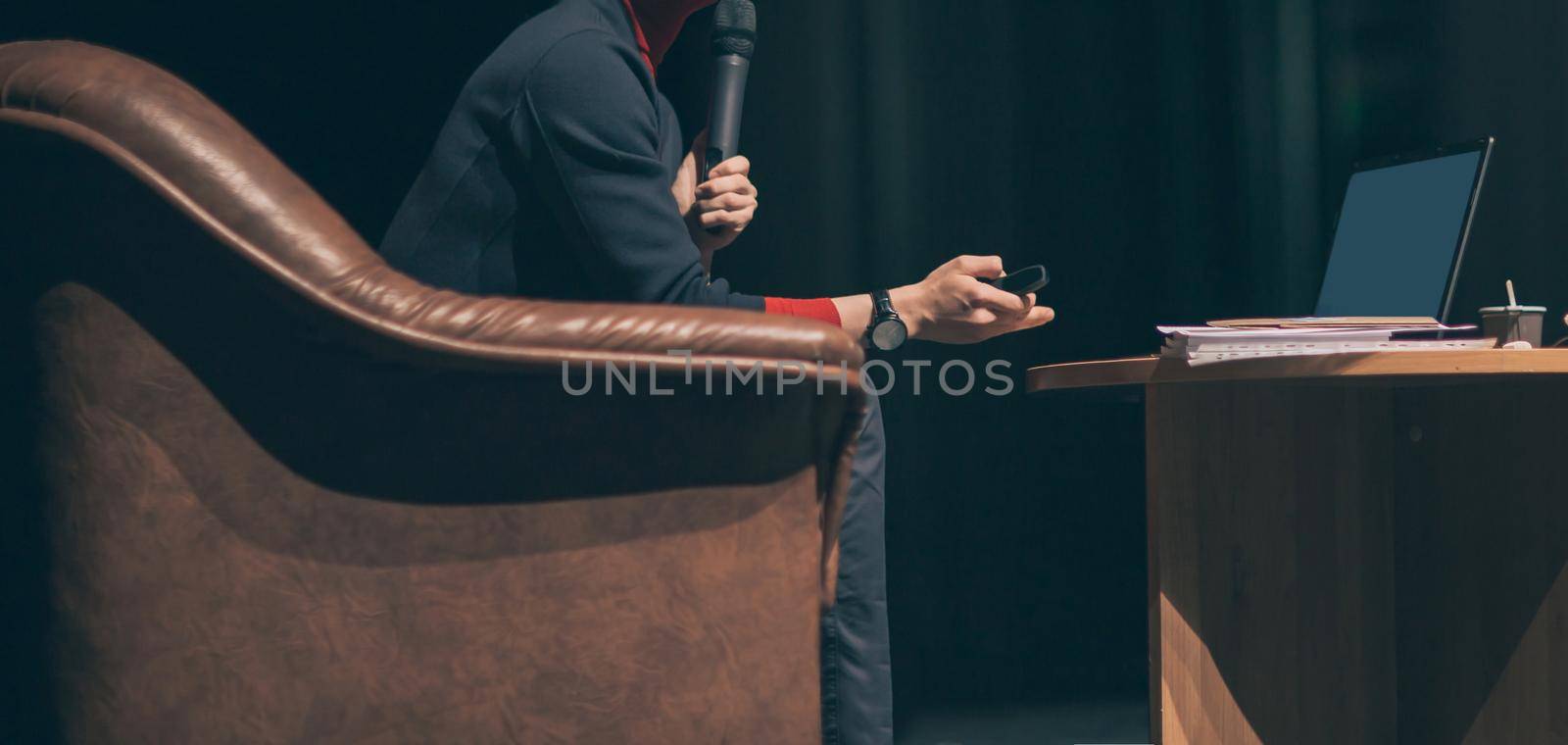 side view. business coach sitting in a chair in front of an open laptop. by SmartPhotoLab