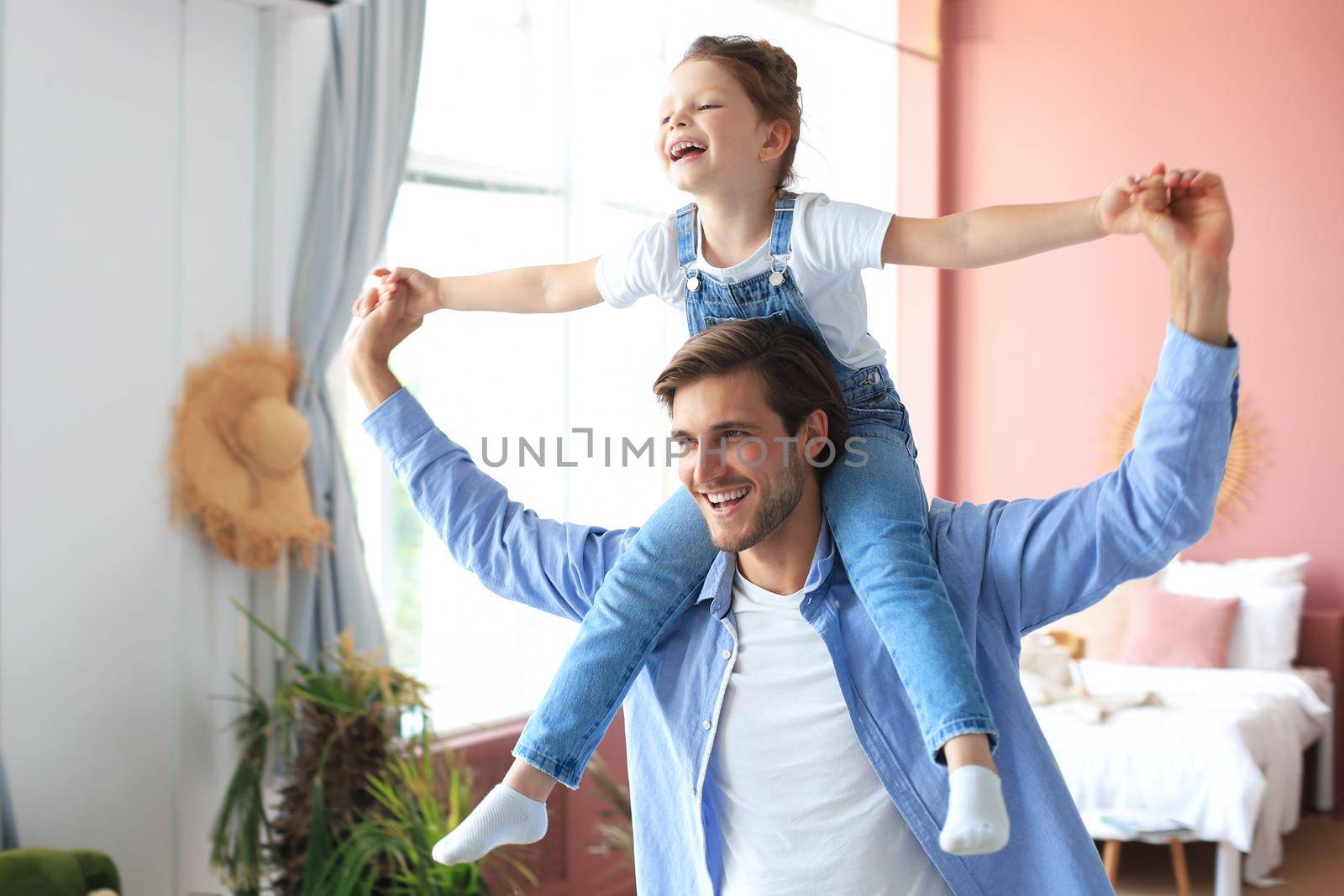 Father and his daughter child girl playing together. Father's day concept.