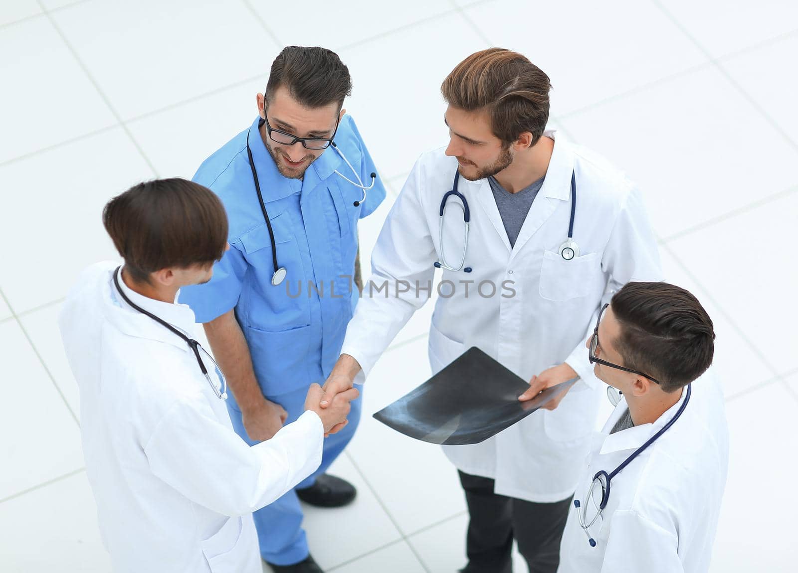 view from the top. handshake two doctors at the meeting.isolated on white