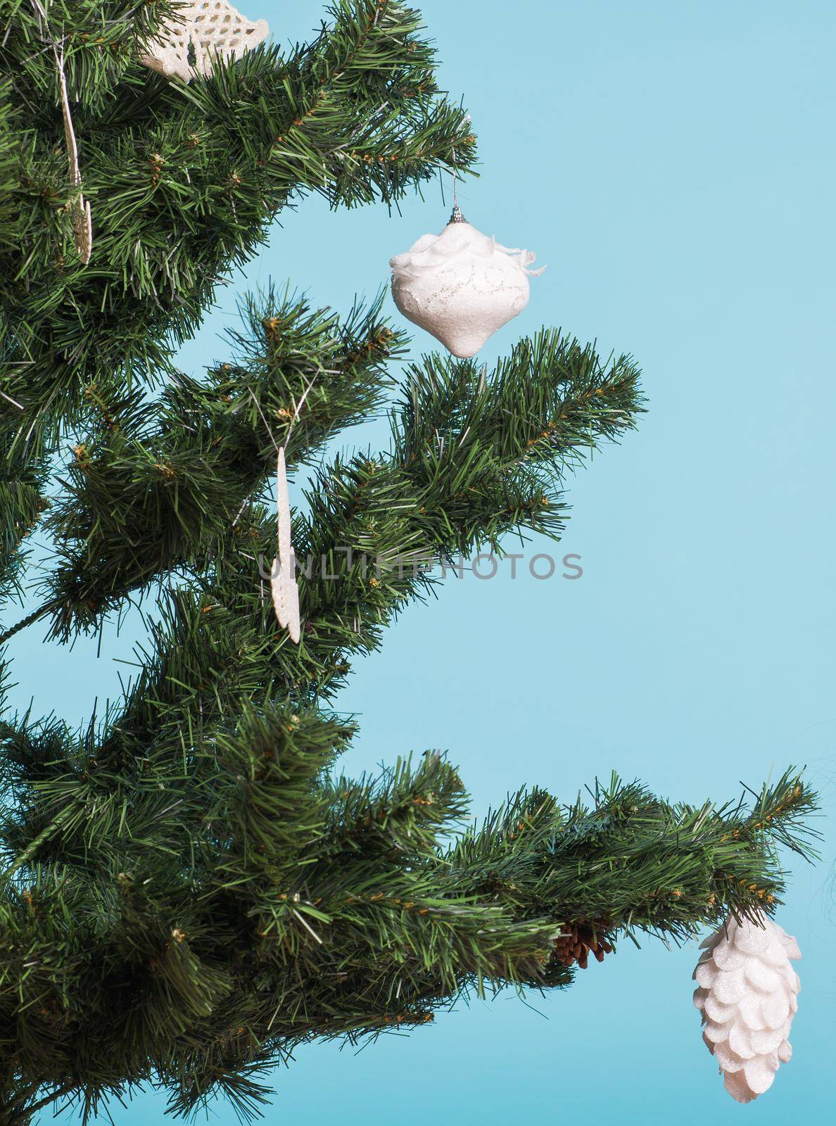 close up on Christmas tree and Christmas decorations on blue background by Satura86