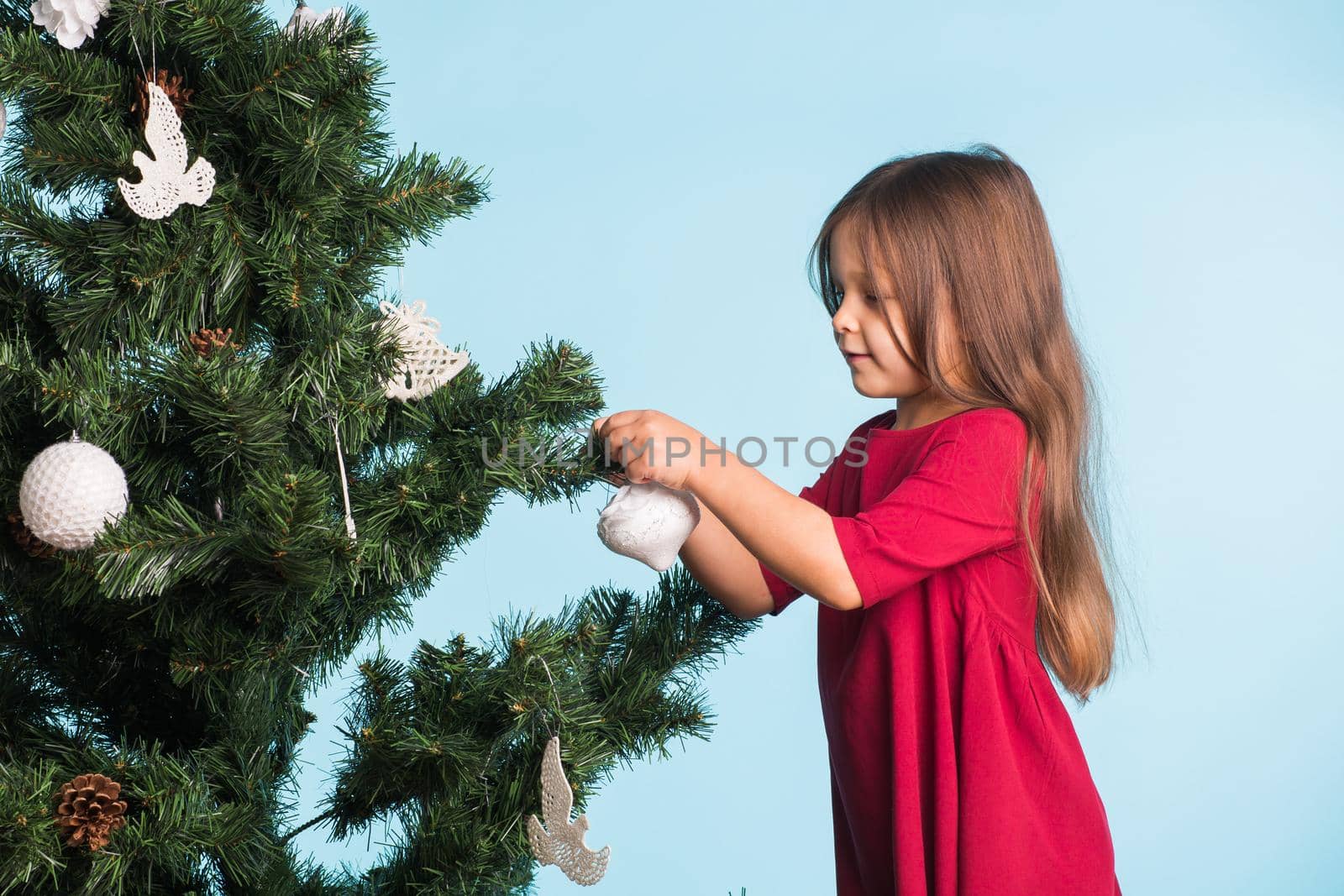 Little girl with christmas tree on blue background by Satura86