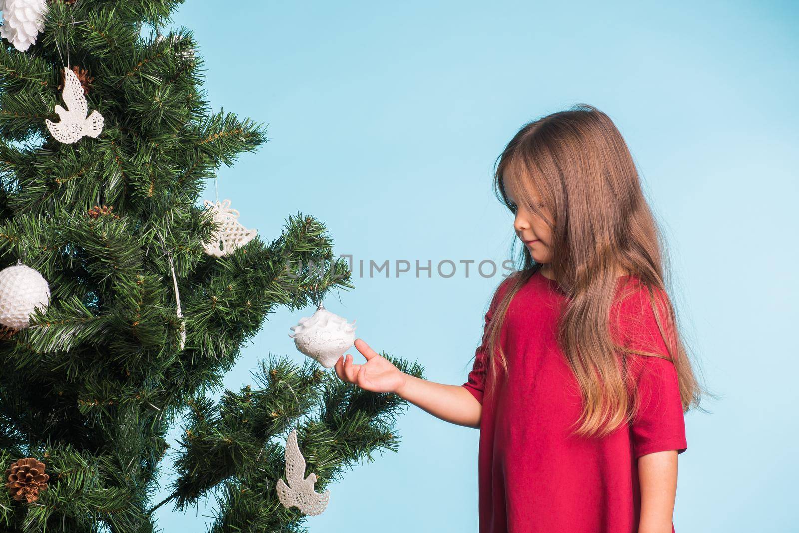 Little girl with christmas tree on blue background by Satura86