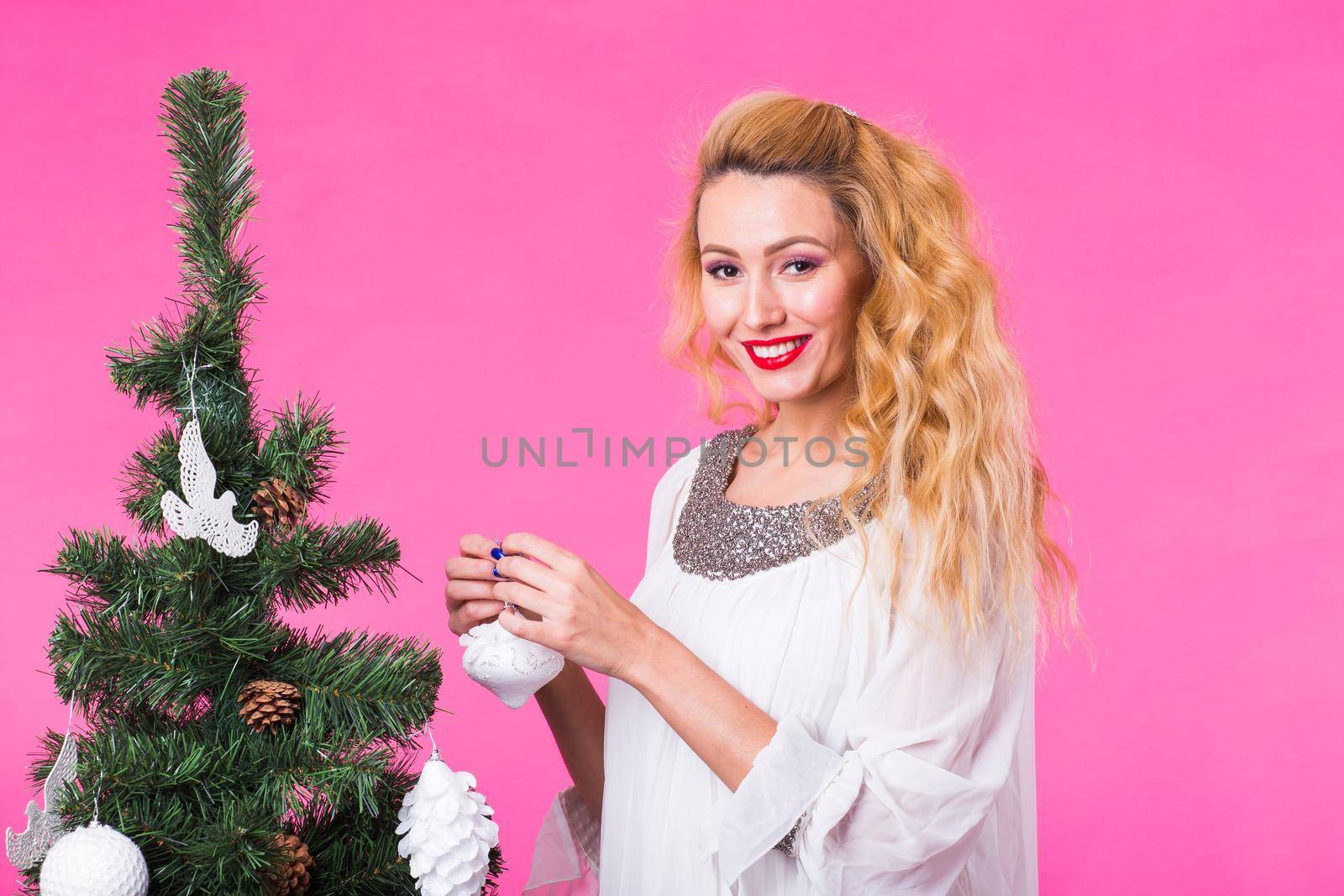 Woman near christmas tree on pink background by Satura86