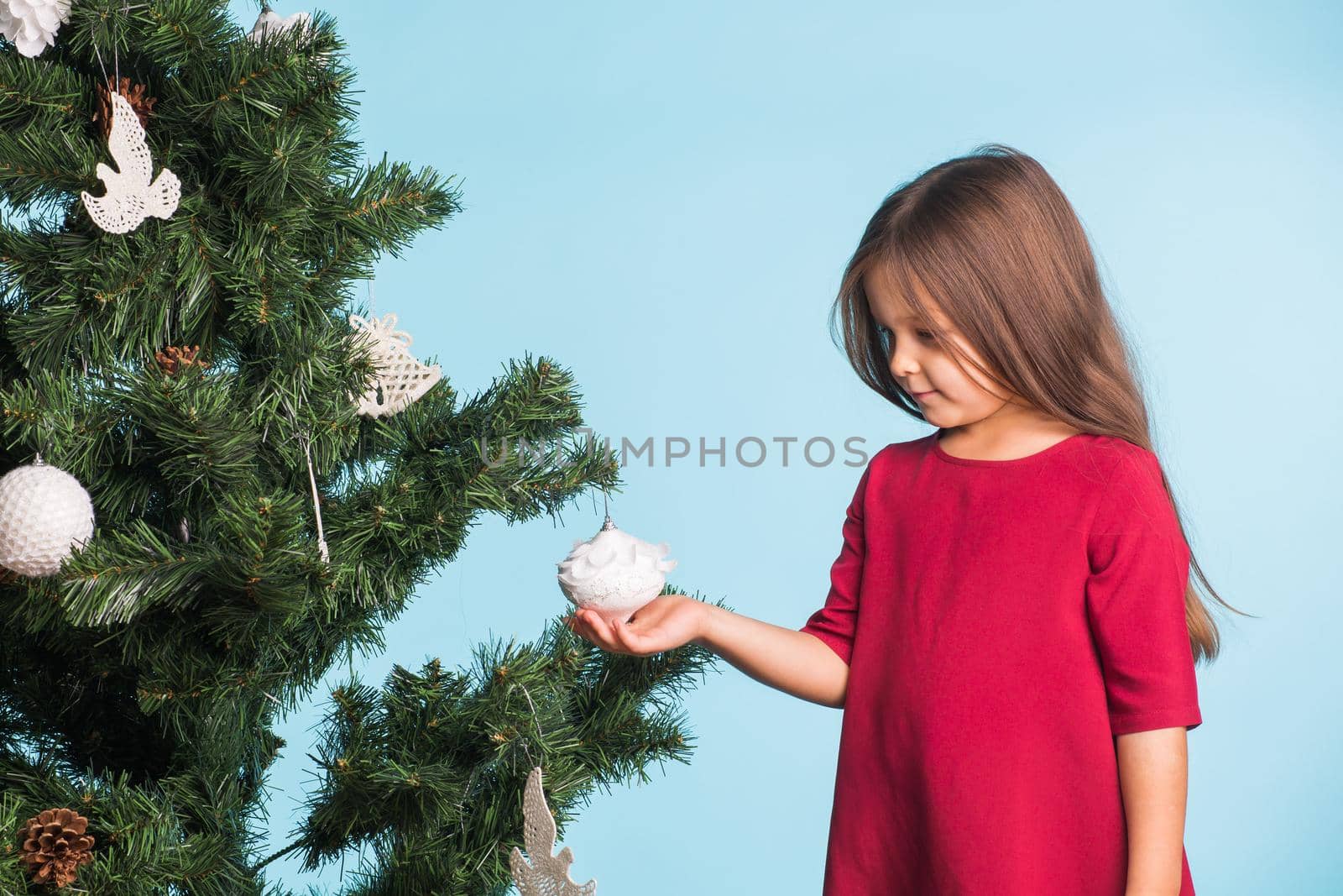 Little girl with christmas tree on blue background by Satura86