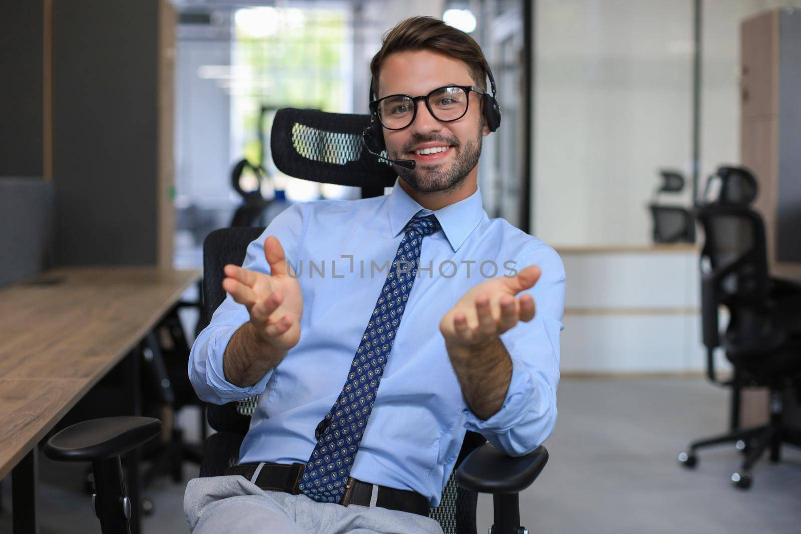 Smiling friendly handsome young male call centre operator