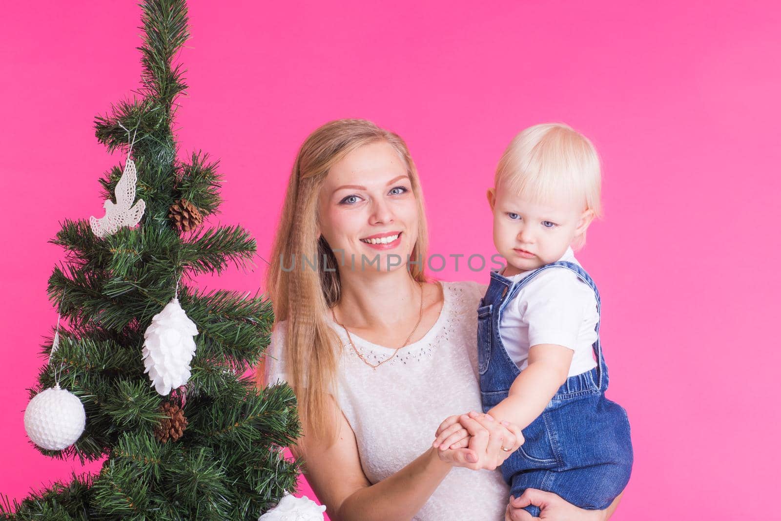 Christmas and holiday concept - Portrait of smiling woman with her little daughter and Christmas tree by Satura86