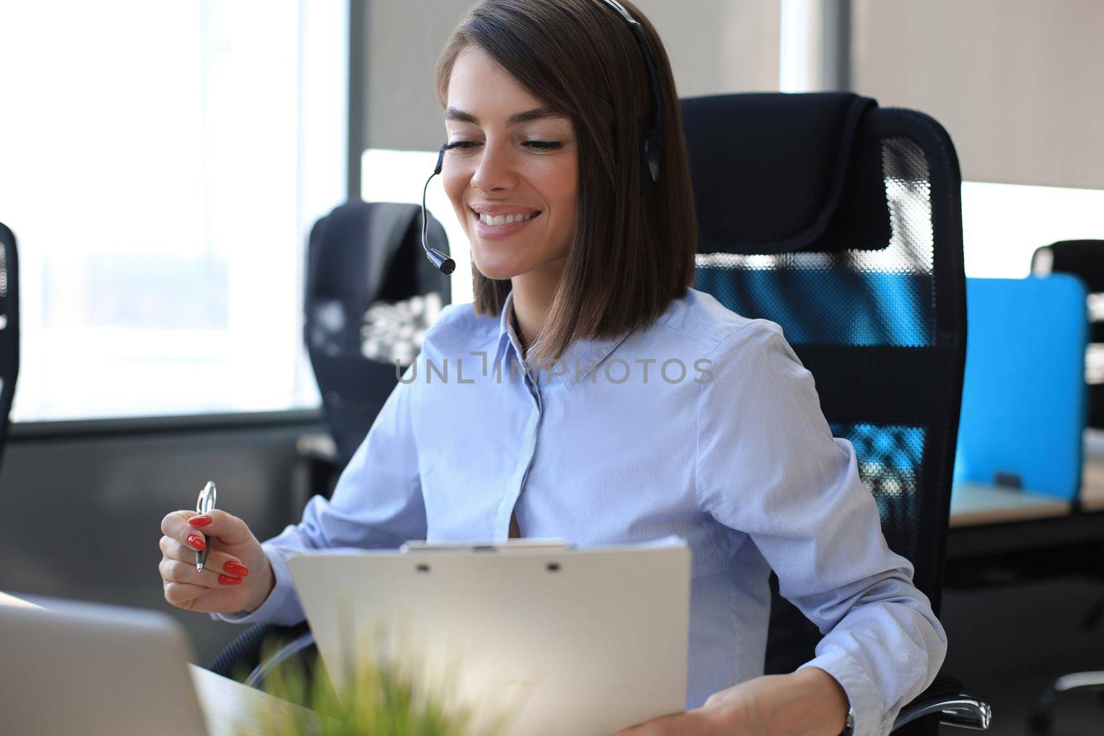 Female customer support operator with headset and smiling