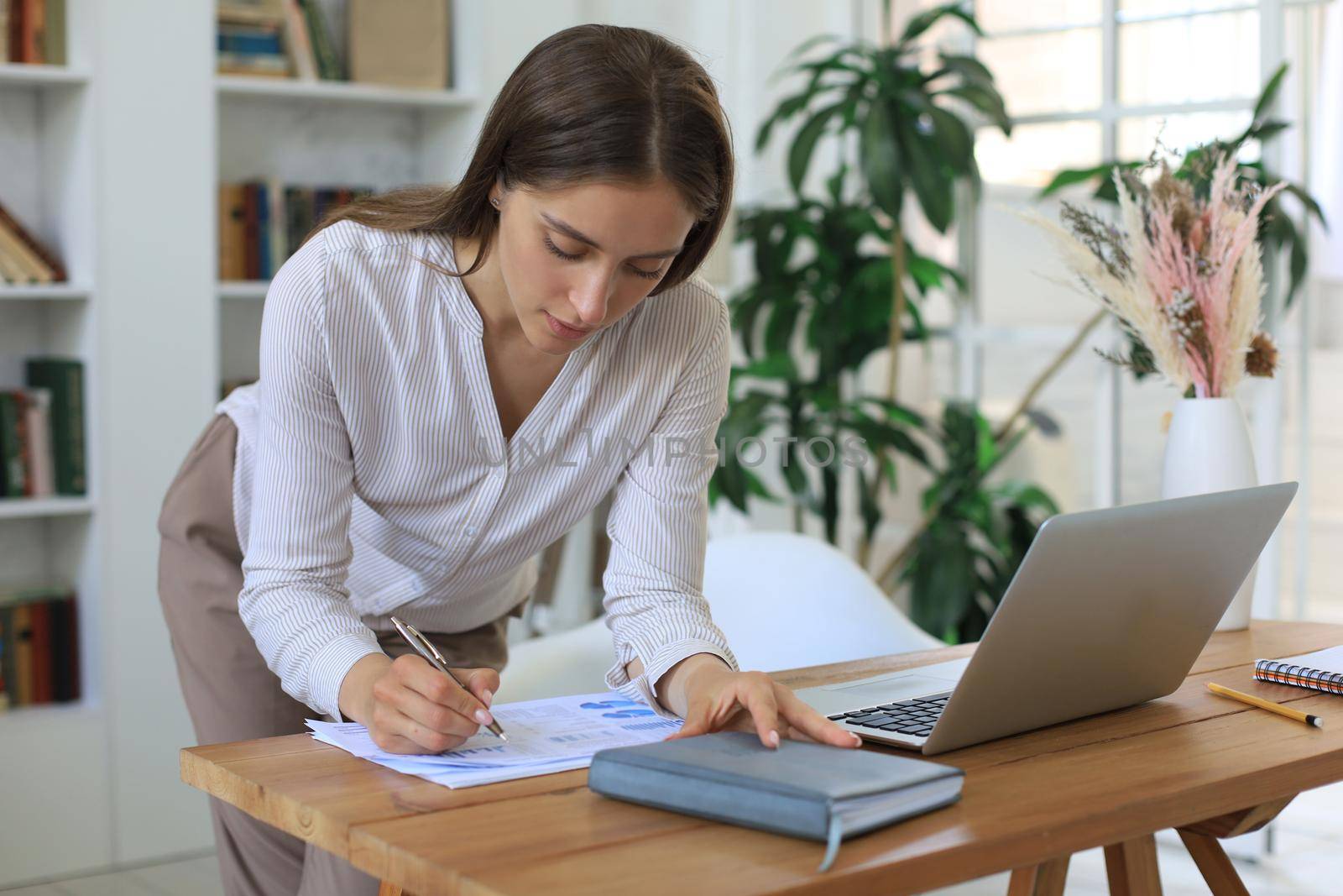 Attractive cheerful business woman working in office
