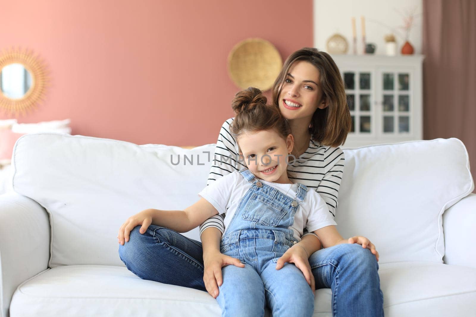 Happy loving mom hugging little daughter, spend time together at home