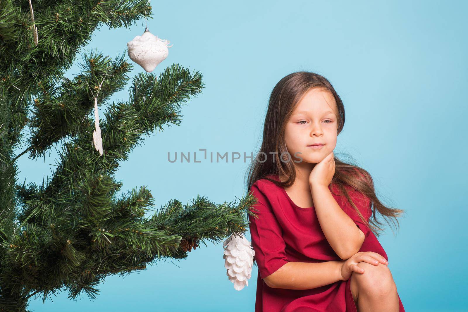 Little girl with christmas tree on blue background by Satura86