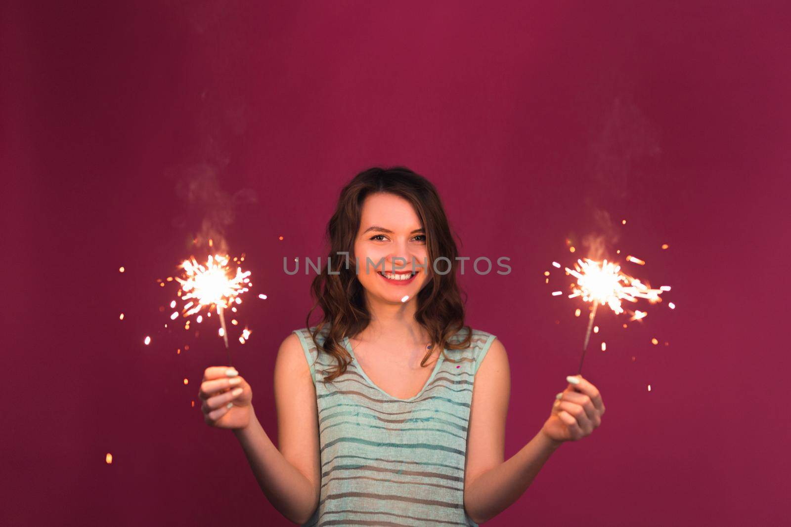 Young woman having fun with a sparkler