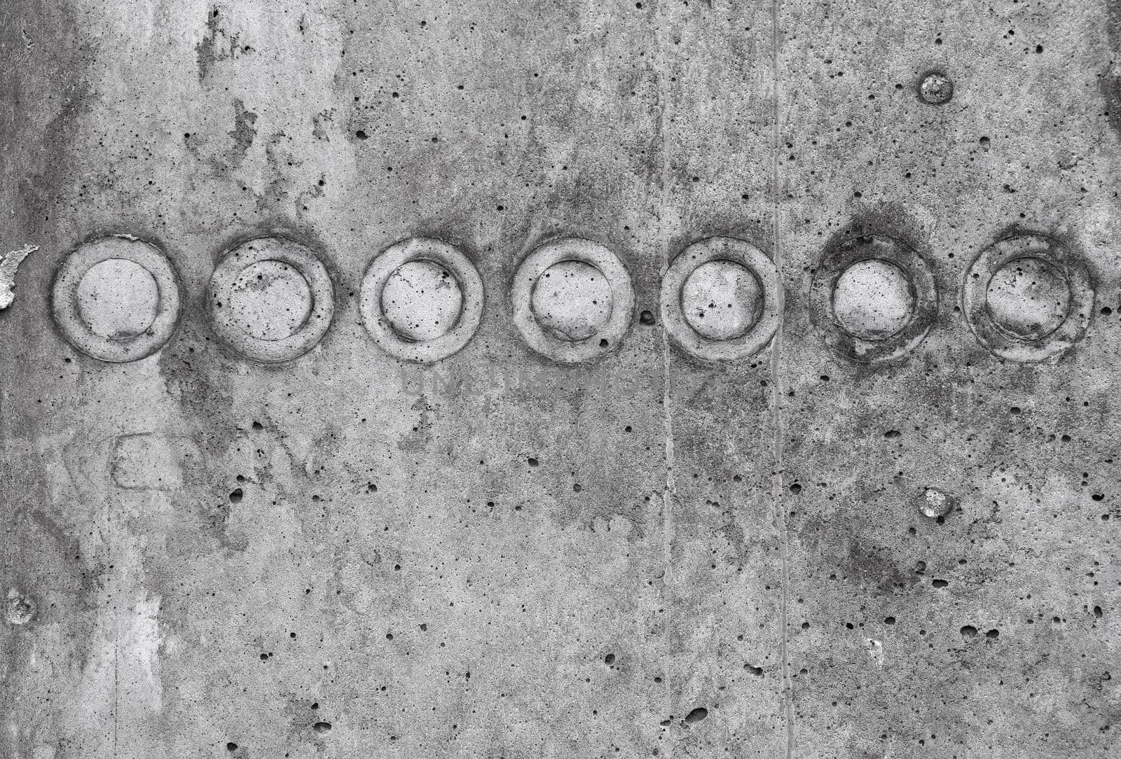 Grunge grey uneven stone surface texture background with dark stains