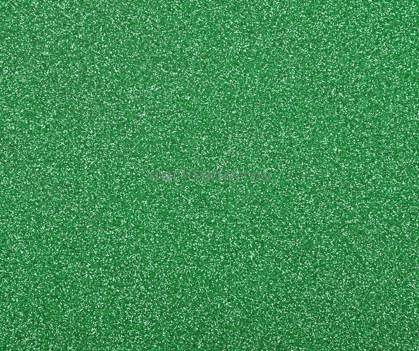 Abstract background texture of shiny colorful vivid green glitter noise pattern