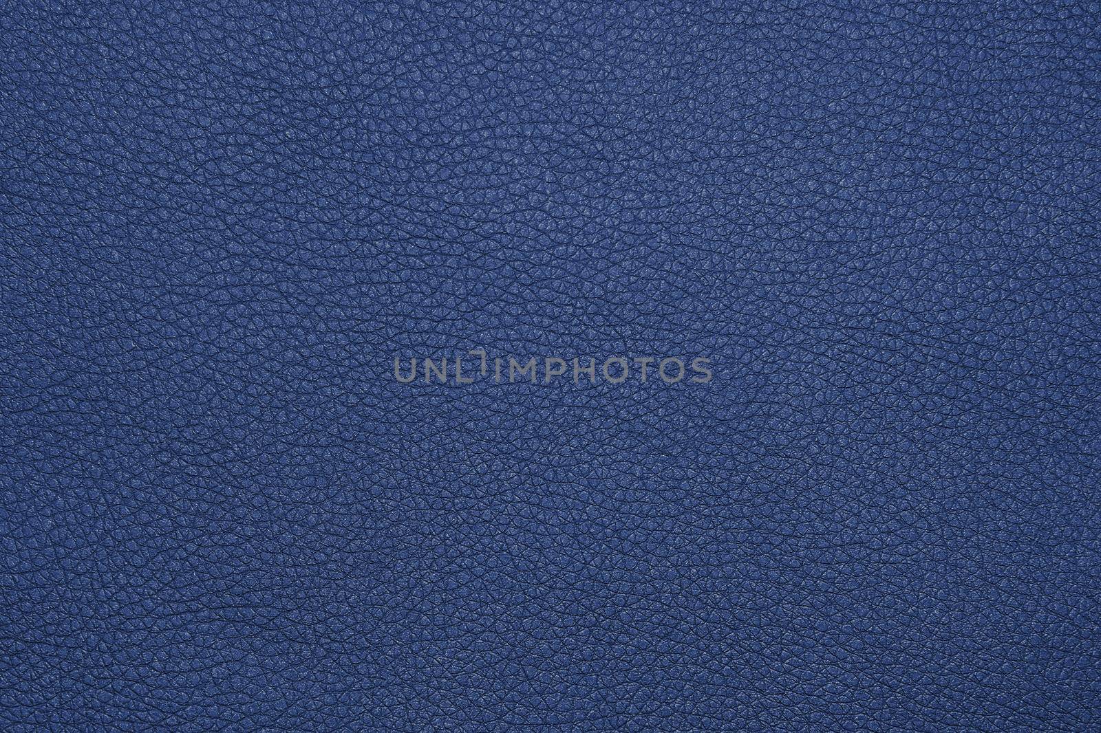 Close up background texture pattern of indigo blue natural leather grain, directly above