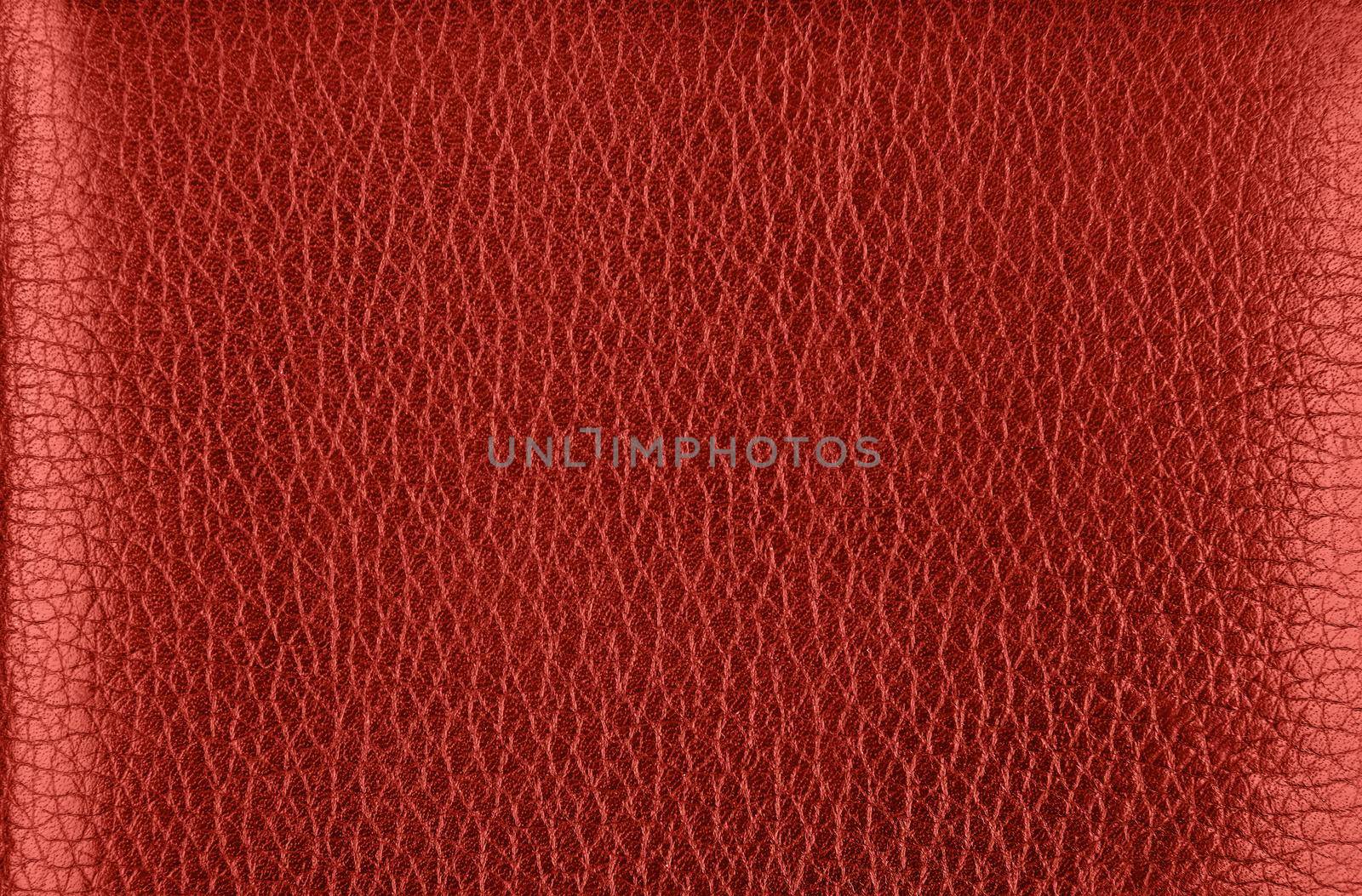 Close up background texture pattern of maroon red natural leather grain, directly above