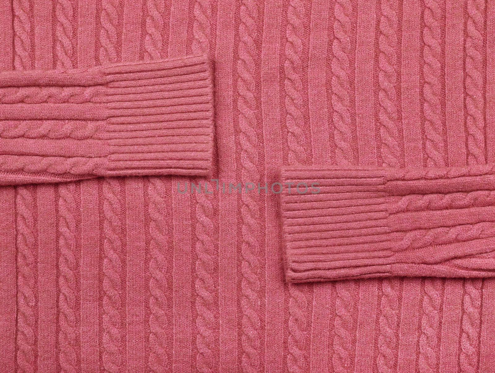 Close up background texture of pink cable knitted wool jersey fabric sweater with row braid pattern