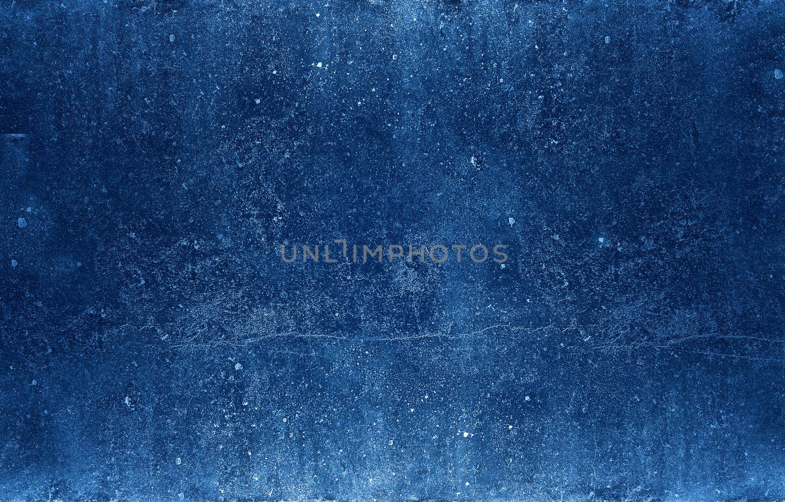 Grunge uneven dark blue stone texture background with cracks and stains