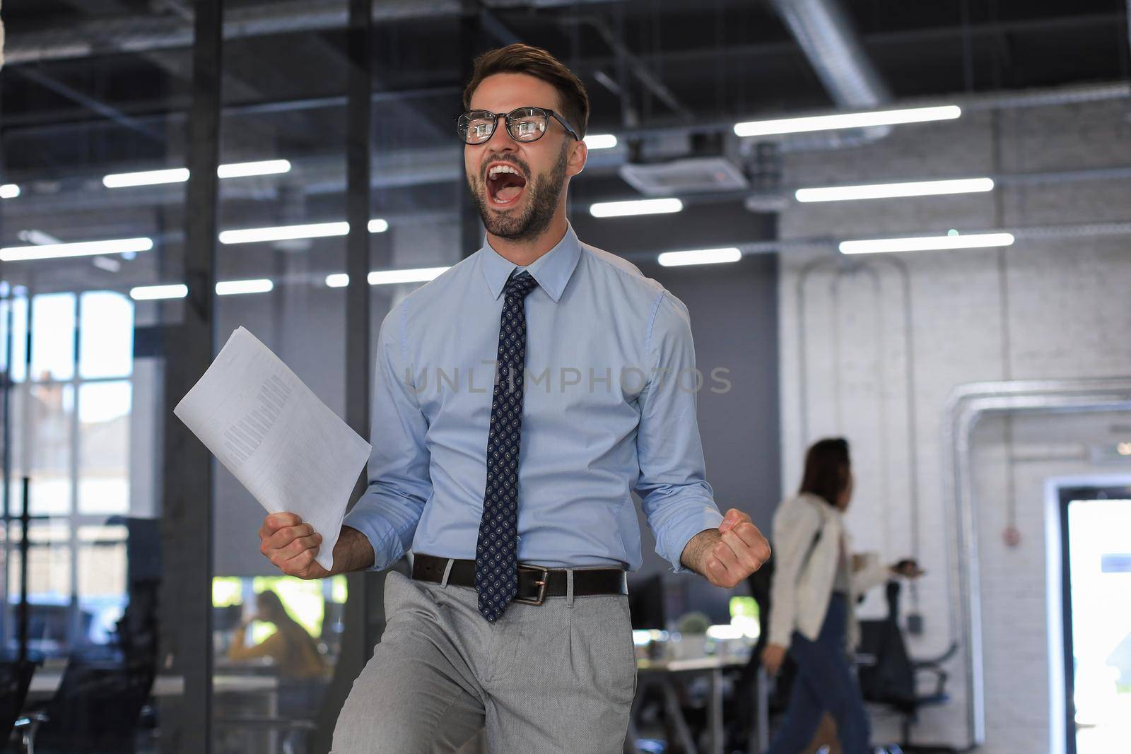 Excited business man celebrating success in the office