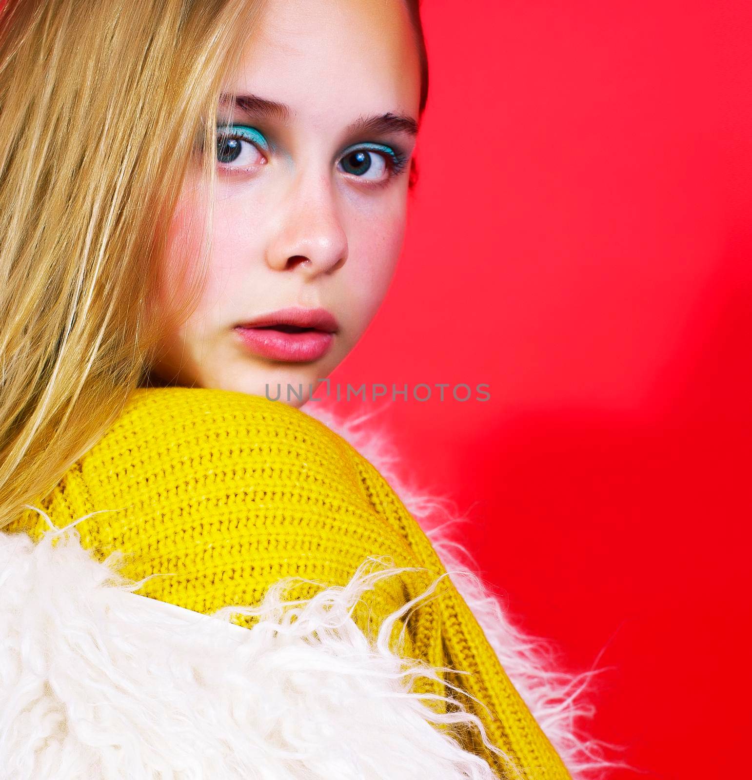 young pretty emitonal posing teenage girl on bright red background, happy smiling lifestyle people concept close up