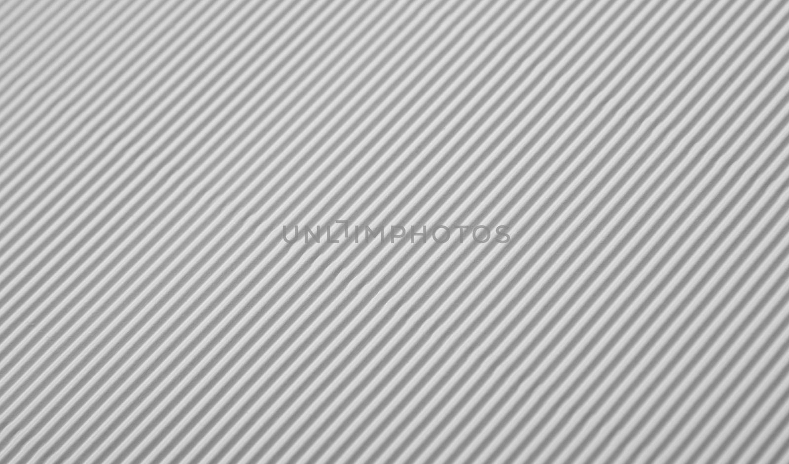 Close up diagonal background pattern texture of white corrugated packaging cardboard