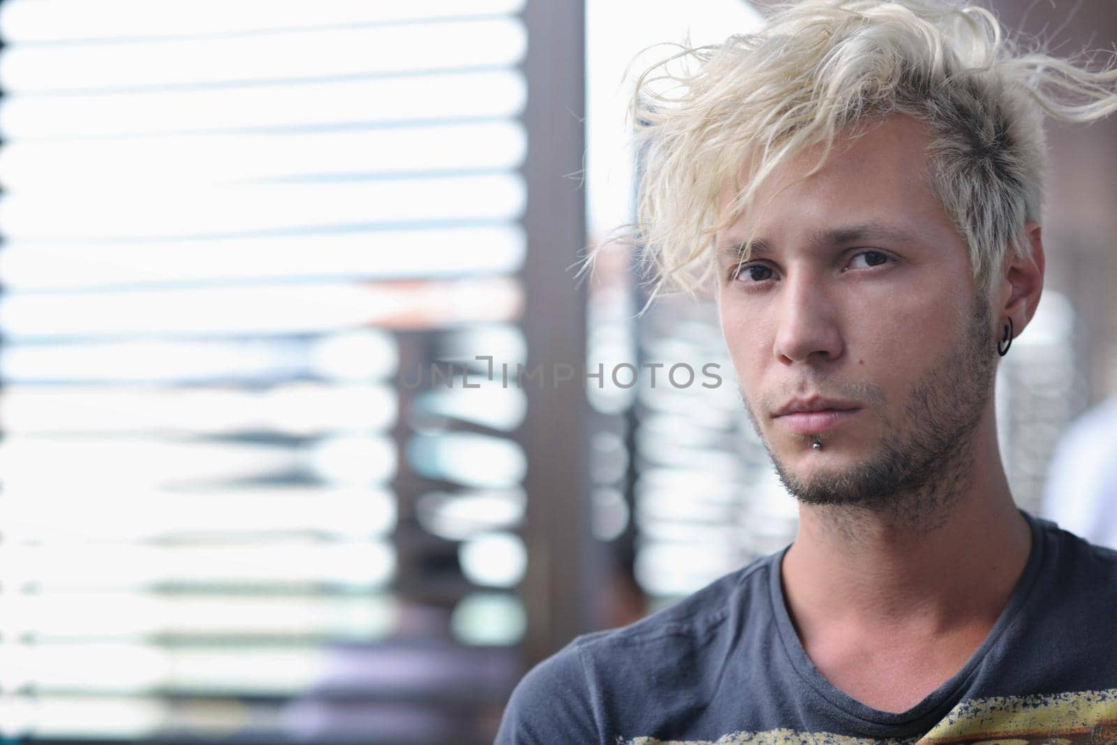 Portrait of an handsome young  man  with urban background and fashion clothes style