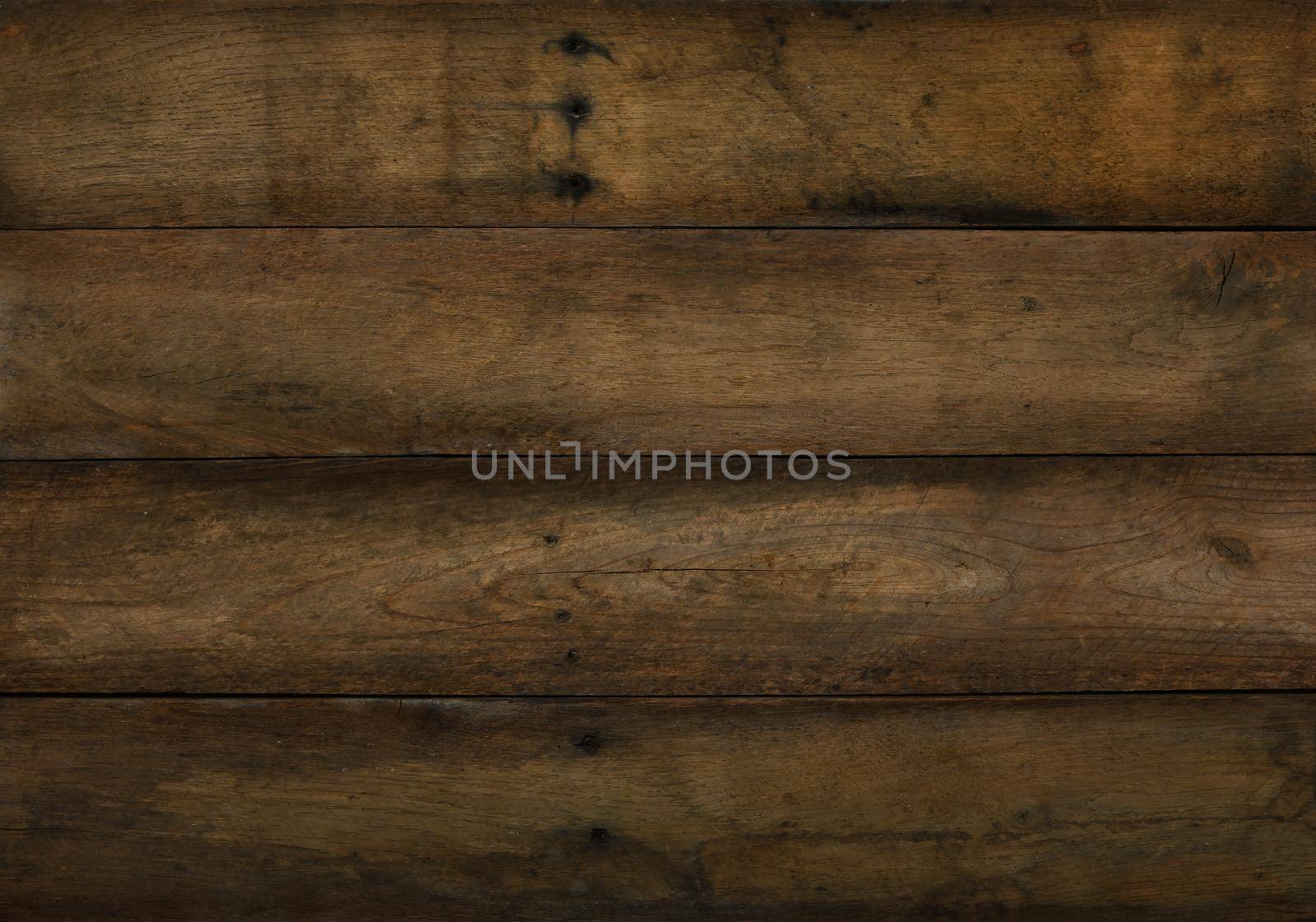 Close uo old vintage brown wooden planks background texture with scratches and black stains over wood grain